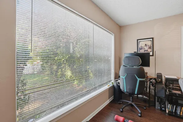 a view of a workspace with furniture and a window