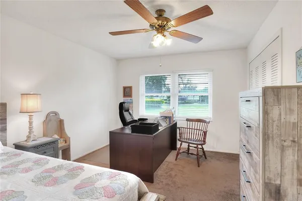 a bedroom with a bed window and a table