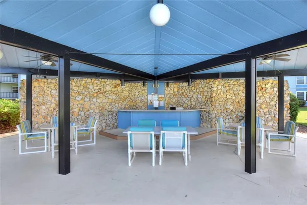 a view of a patio with a table chairs and backyard