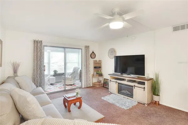 a living room with furniture and potted plant