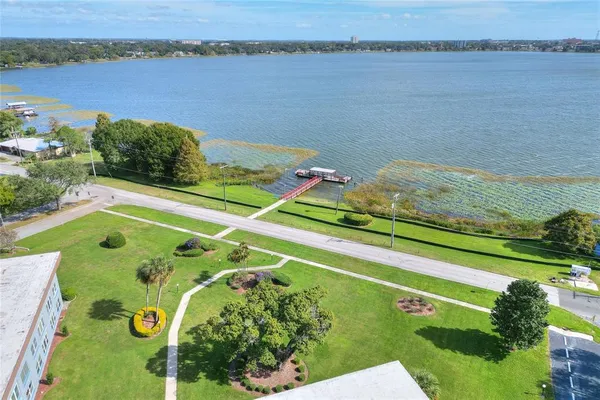 a view of a swimming pool with a patio and a lake view