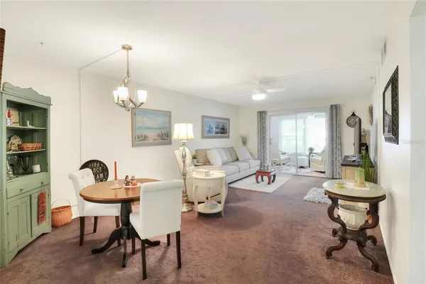 a sink sitting area in a kitchen with white cabinets