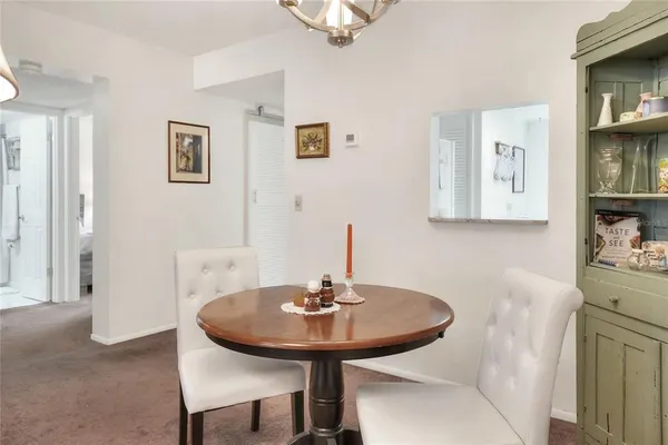 a view of a dining room with a table and chairs
