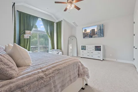 a spacious bedroom with a bed and a large window