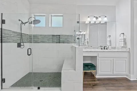 a bathroom with a sink double vanity and shower