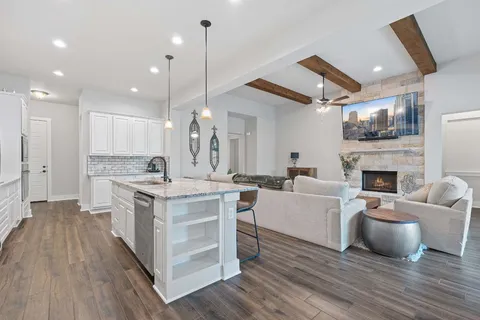 a large kitchen with cabinets a sink and a fireplace