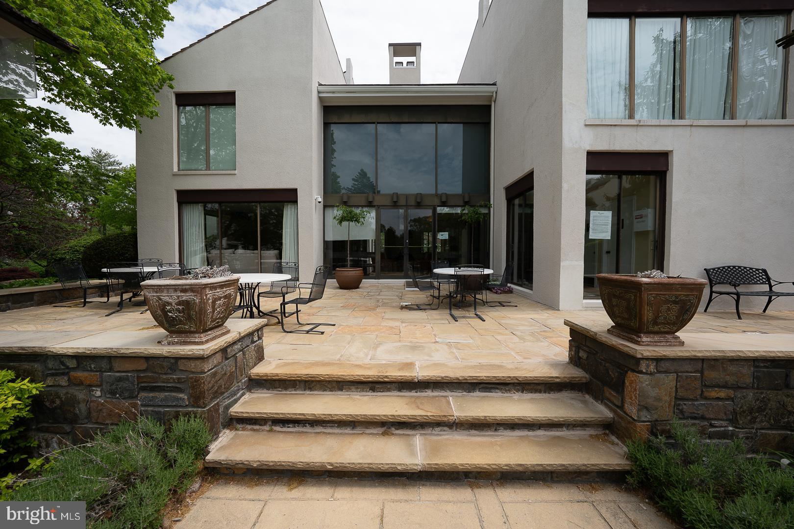 10 Brettagne, Unit 10 Devon, PA 19333 - Photo 41 of 46 a view of the patio with couches and potted plants