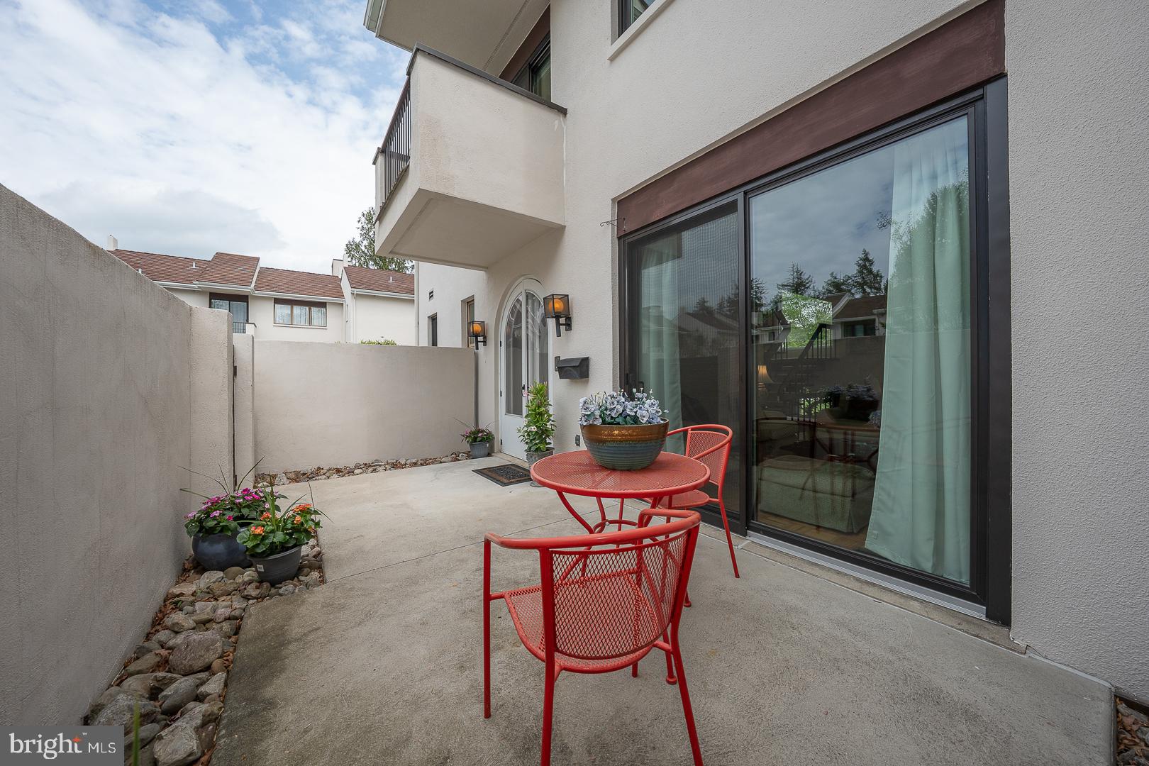 10 Brettagne, Unit 10 Devon, PA 19333 - Photo 5 of 46 a patio with table and chairs and potted plants