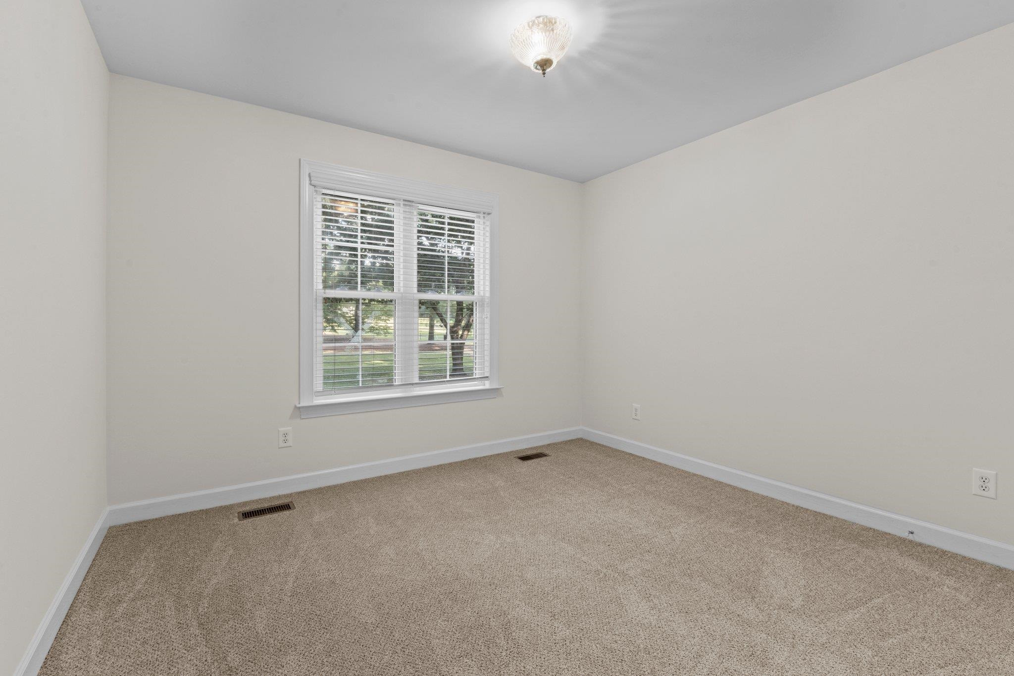 8025 Lockleair Road Zebulon, NC 27597 - Photo 20 of 30 bedroom features fresh paint and spacious closet Bedroom #2