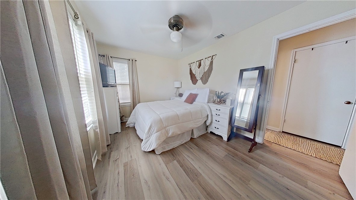4805 Alice Street Corpus Christi, TX 78411 - Photo 12 of 19 a bedroom with a bed mirror and window