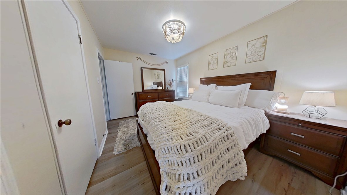 4805 Alice Street Corpus Christi, TX 78411 - Photo 14 of 19 a bedroom with a bed and a lamp on dresser