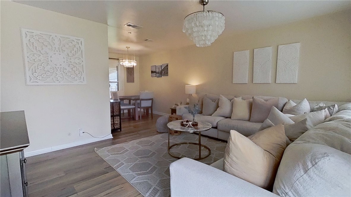 4805 Alice Street Corpus Christi, TX 78411 - Photo 3 of 19 a living room with furniture a dining table and a chandelier