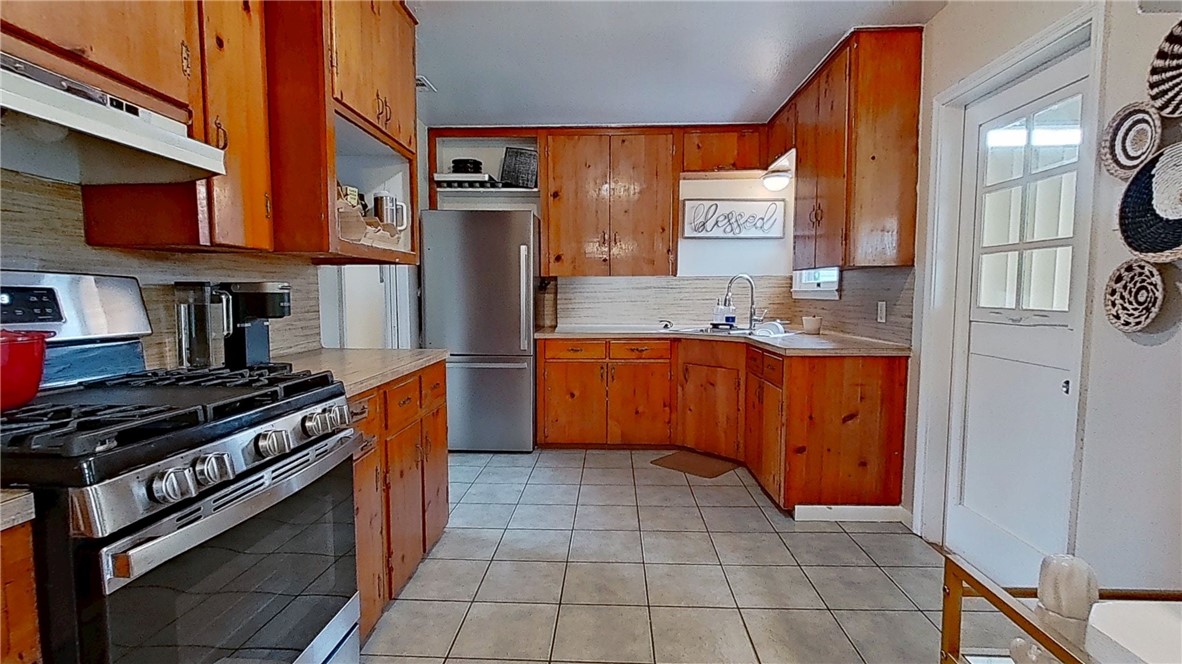 4805 Alice Street Corpus Christi, TX 78411 - Photo 5 of 19 a kitchen with stainless steel appliances granite countertop a stove a sink and a refrigerator