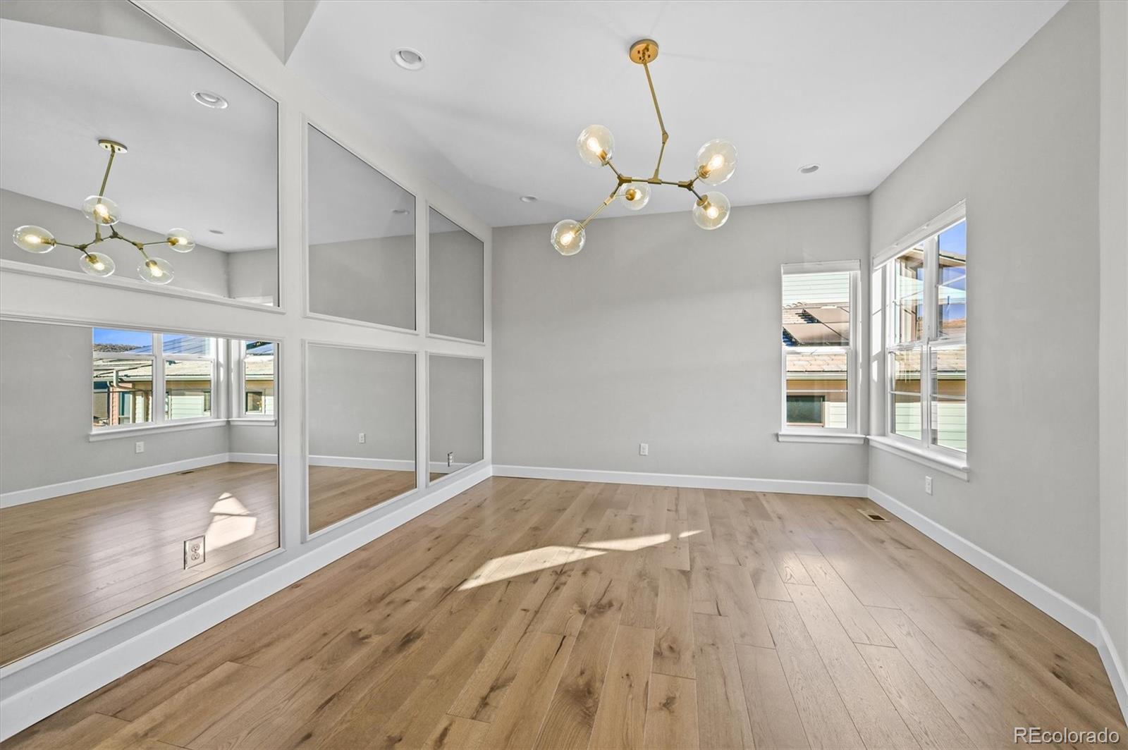 10814 Bluffside Drive Lone Tree, CO 80124 - Photo 16 of 50 a view of an empty room with a window and wooden floor