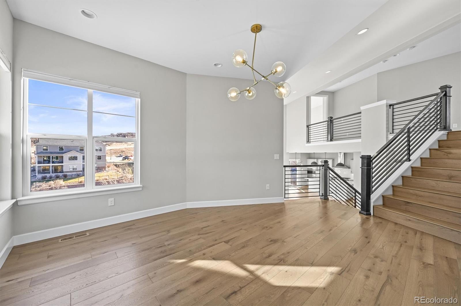 10814 Bluffside Drive Lone Tree, CO 80124 - Photo 17 of 50 an empty room with wooden floor fan and windows