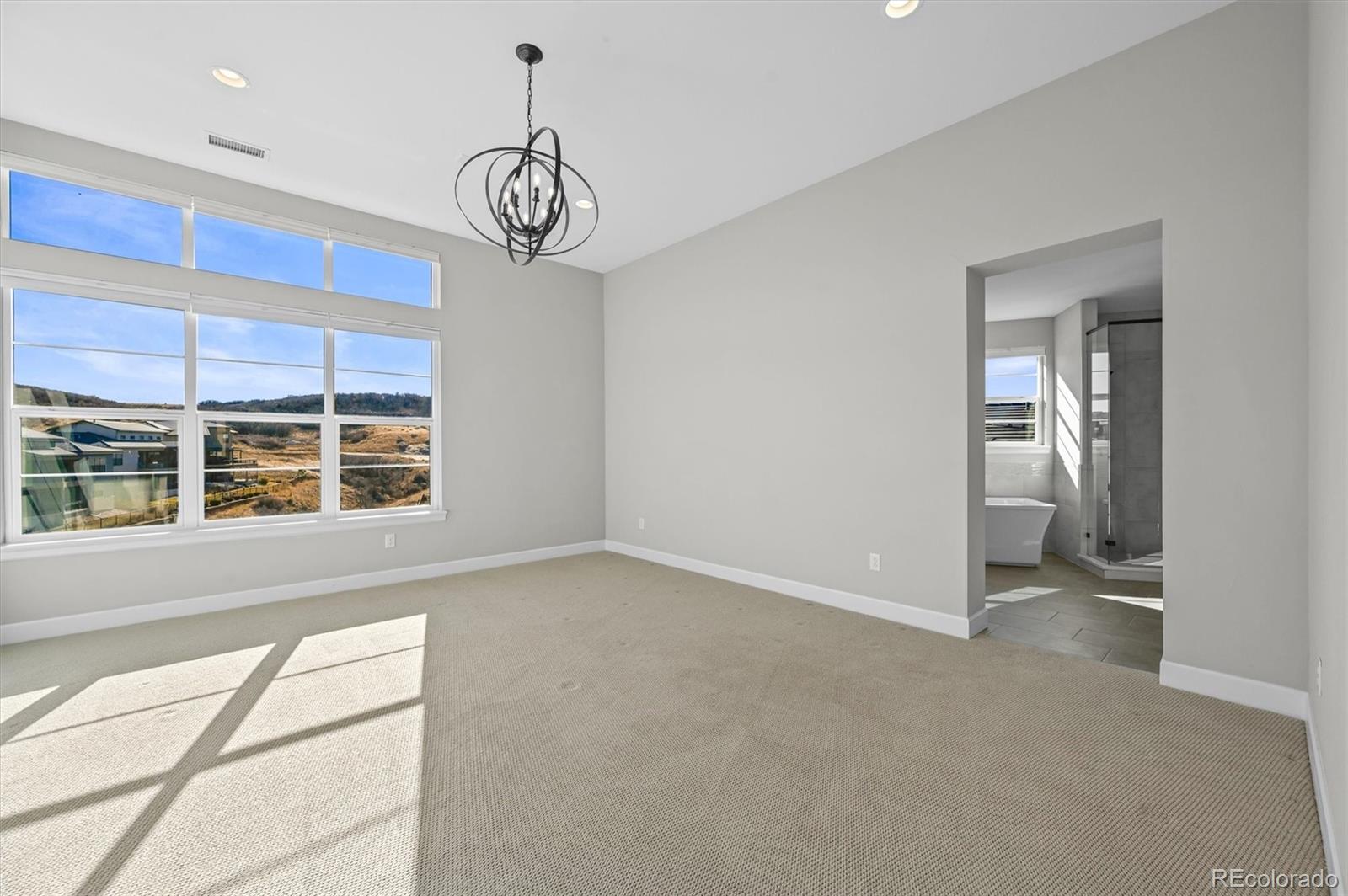 10814 Bluffside Drive Lone Tree, CO 80124 - Photo 18 of 50 a view of an empty room with a window and wooden floor