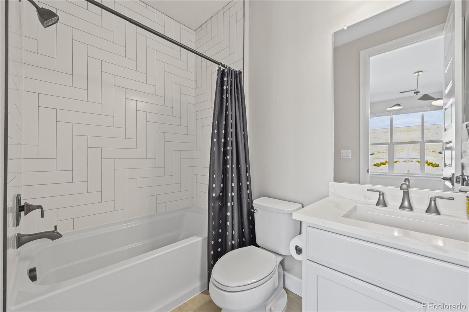 10814 Bluffside Drive Lone Tree, CO 80124 - Photo 23 of 50 a bathroom with a toilet a sink and bathtub