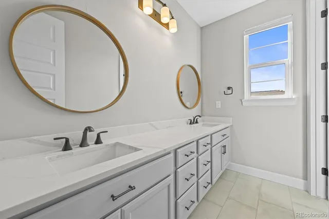 a bathroom with a double vanity sink and a mirror