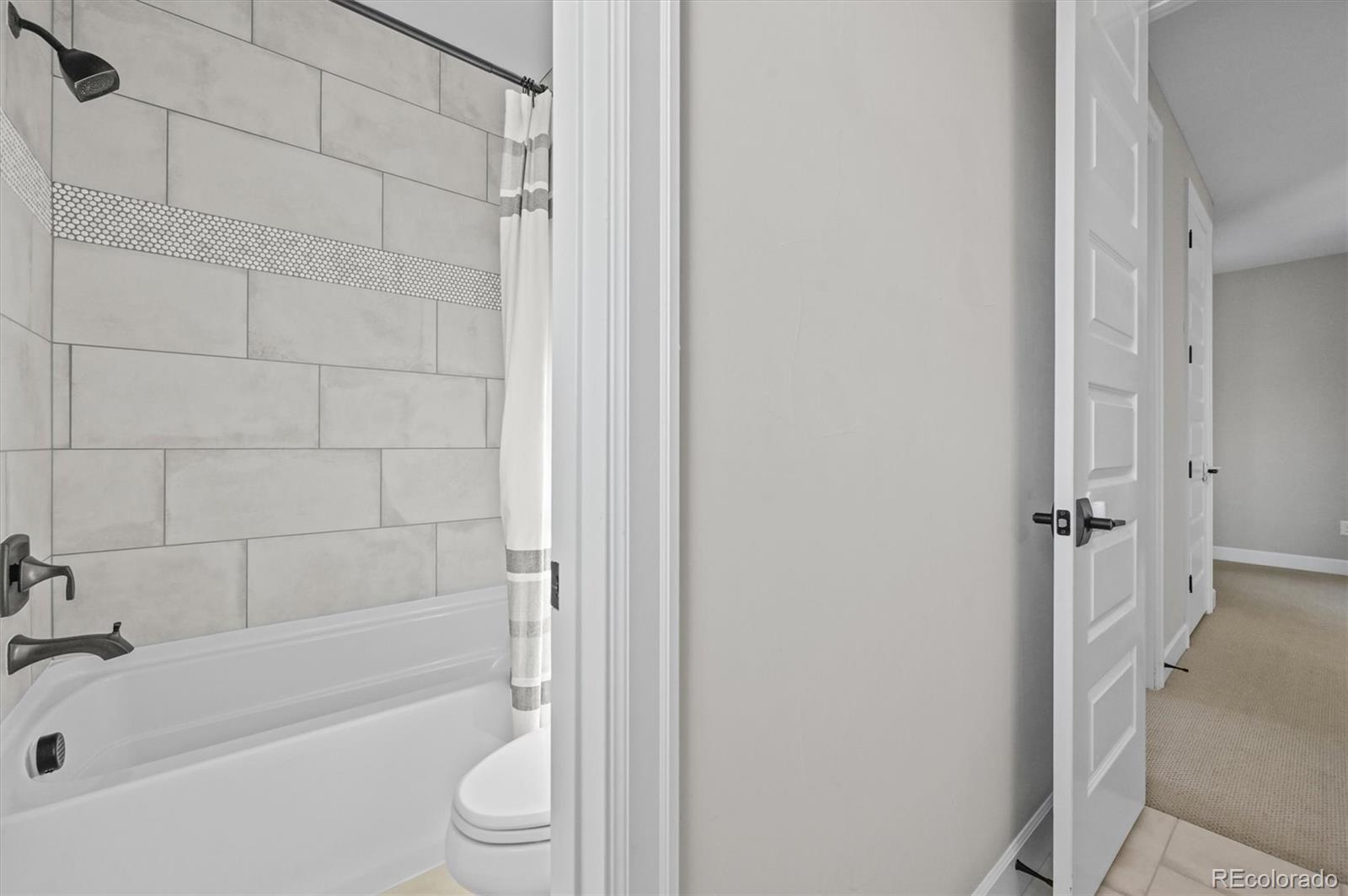 10814 Bluffside Drive Lone Tree, CO 80124 - Photo 26 of 50 a bathroom with a bathtub and a shower