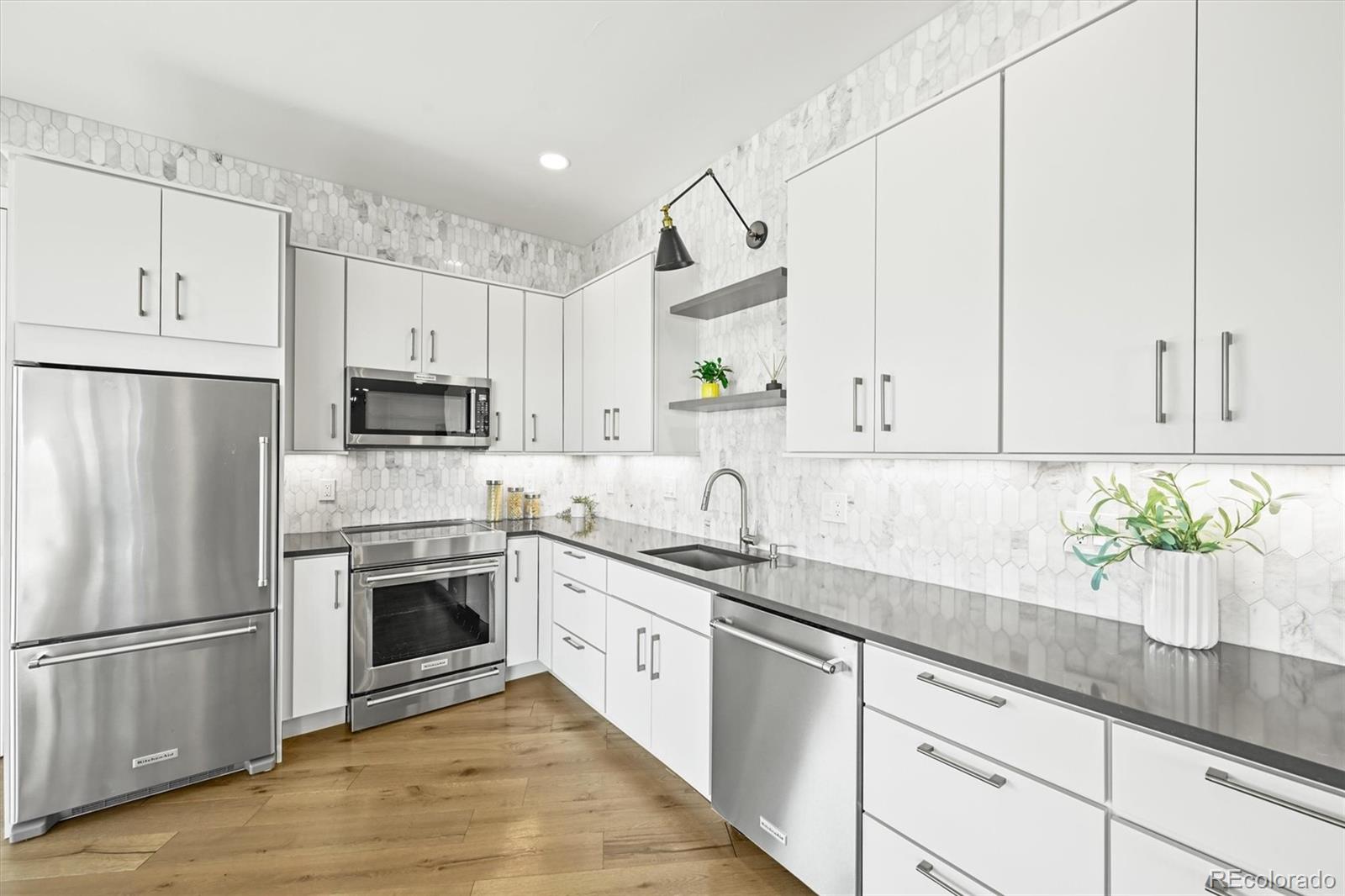 10814 Bluffside Drive Lone Tree, CO 80124 - Photo 32 of 50 a kitchen with stainless steel appliances white cabinets and a sink