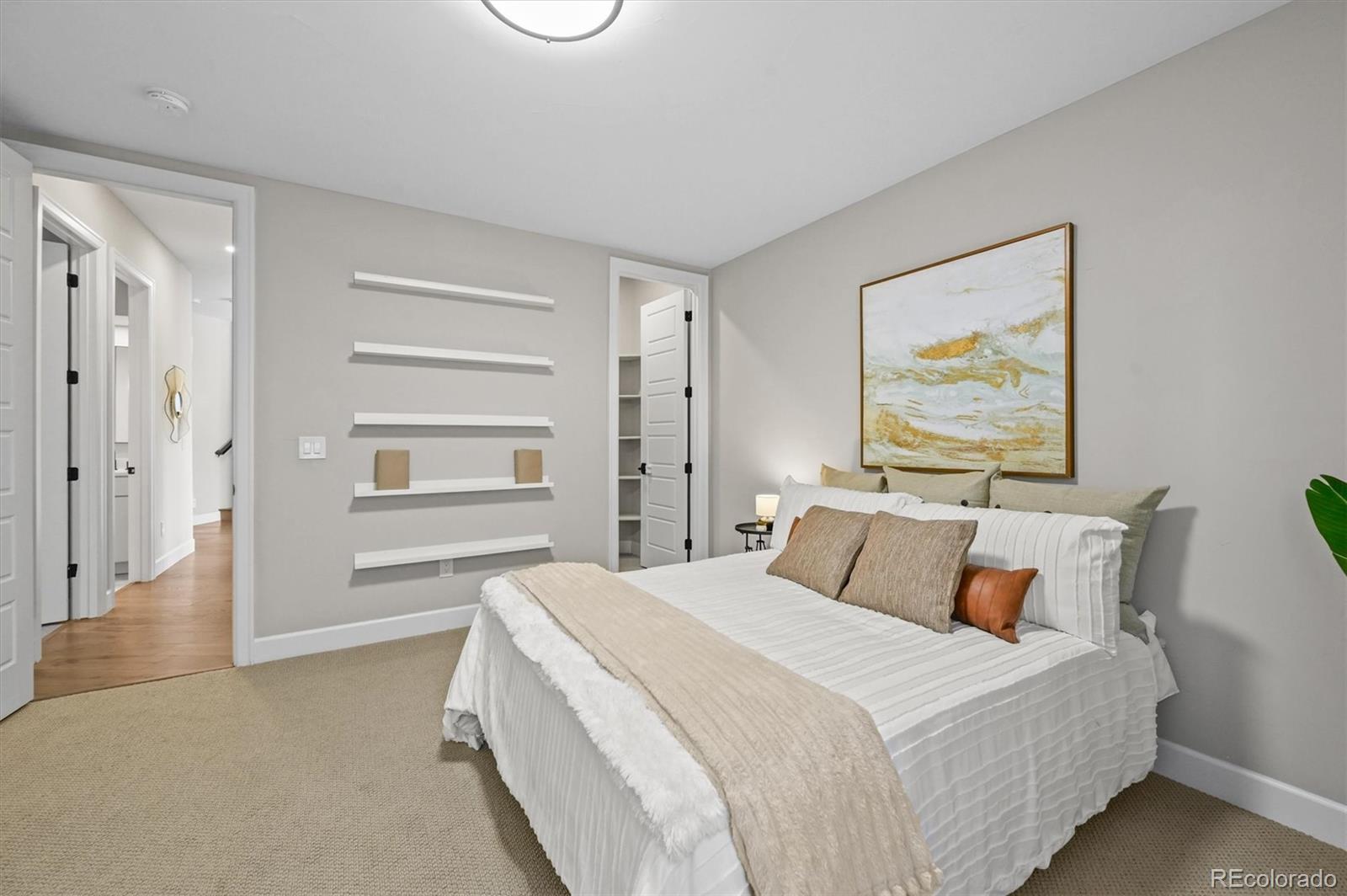 10814 Bluffside Drive Lone Tree, CO 80124 - Photo 38 of 50 a bedroom with a bed and a painting on the wall