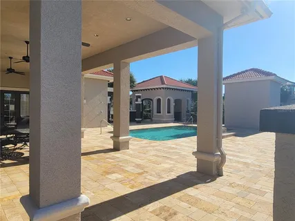a view of a house with backyard porch and sitting area