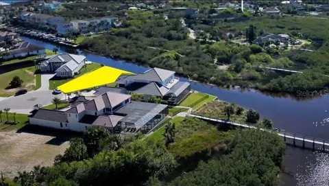an aerial view of a house with a swimming pool outdoor seating and yard