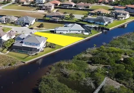 an aerial view of a house with a swimming pool outdoor seating and yard