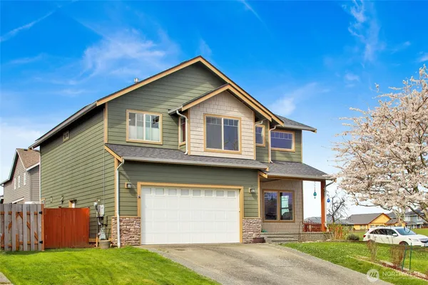 a front view of a house with a yard and garage