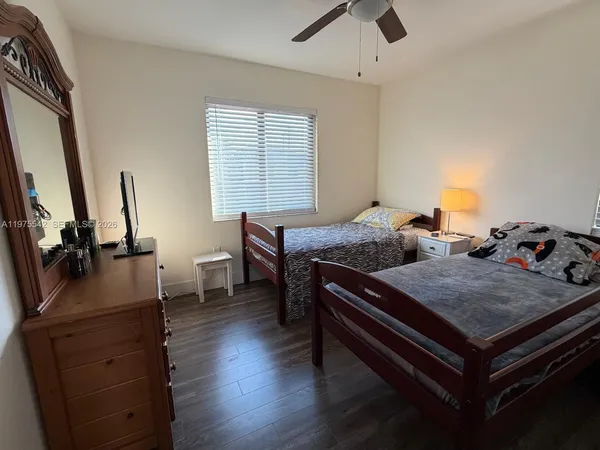 a bedroom with a bed and a potted plant