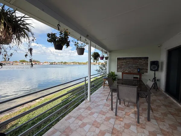 a view of a chairs and table in the balcony