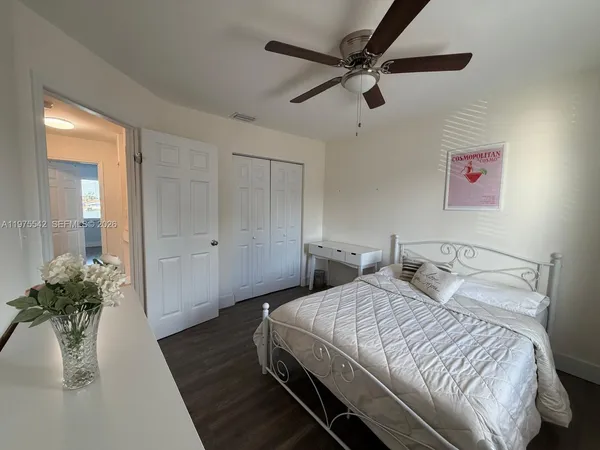 a spacious bathroom with a double vanity sink toilet mirror and shower