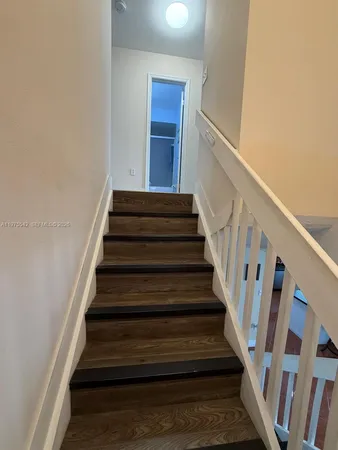 a kitchen with stainless steel appliances a refrigerator sink stove and cabinets
