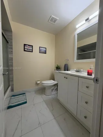 a kitchen with stainless steel appliances kitchen island granite countertop a sink and cabinets