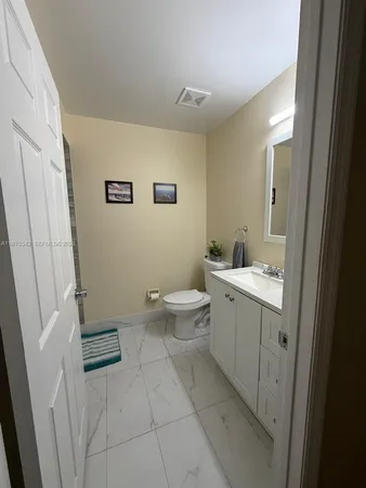 a view of a dining room with furniture and a window