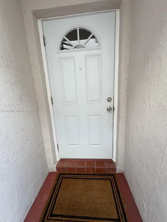 a view of a livingroom with workspace and a window
