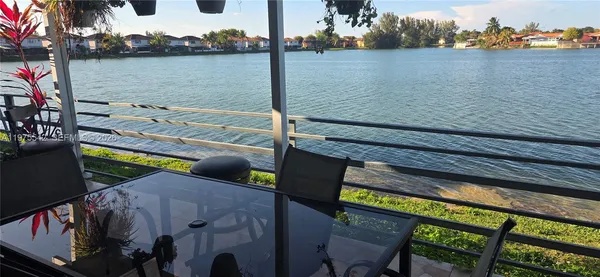 a view of balcony with wooden floor and outdoor seating