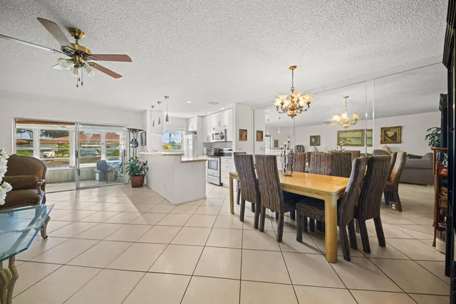 a dining hall view with a dining table chairs and entryway