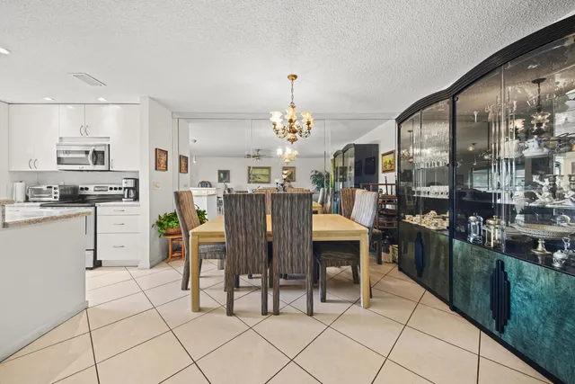 a dining table chairs and a kitchen view