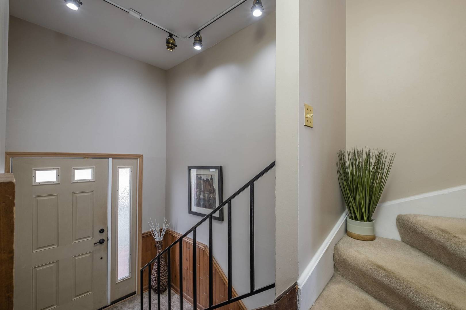 759 North Old Rand Road Lake Zurich, IL 60047 - Photo 16 of 34 a view of a hallway with wooden floor and a potted plant