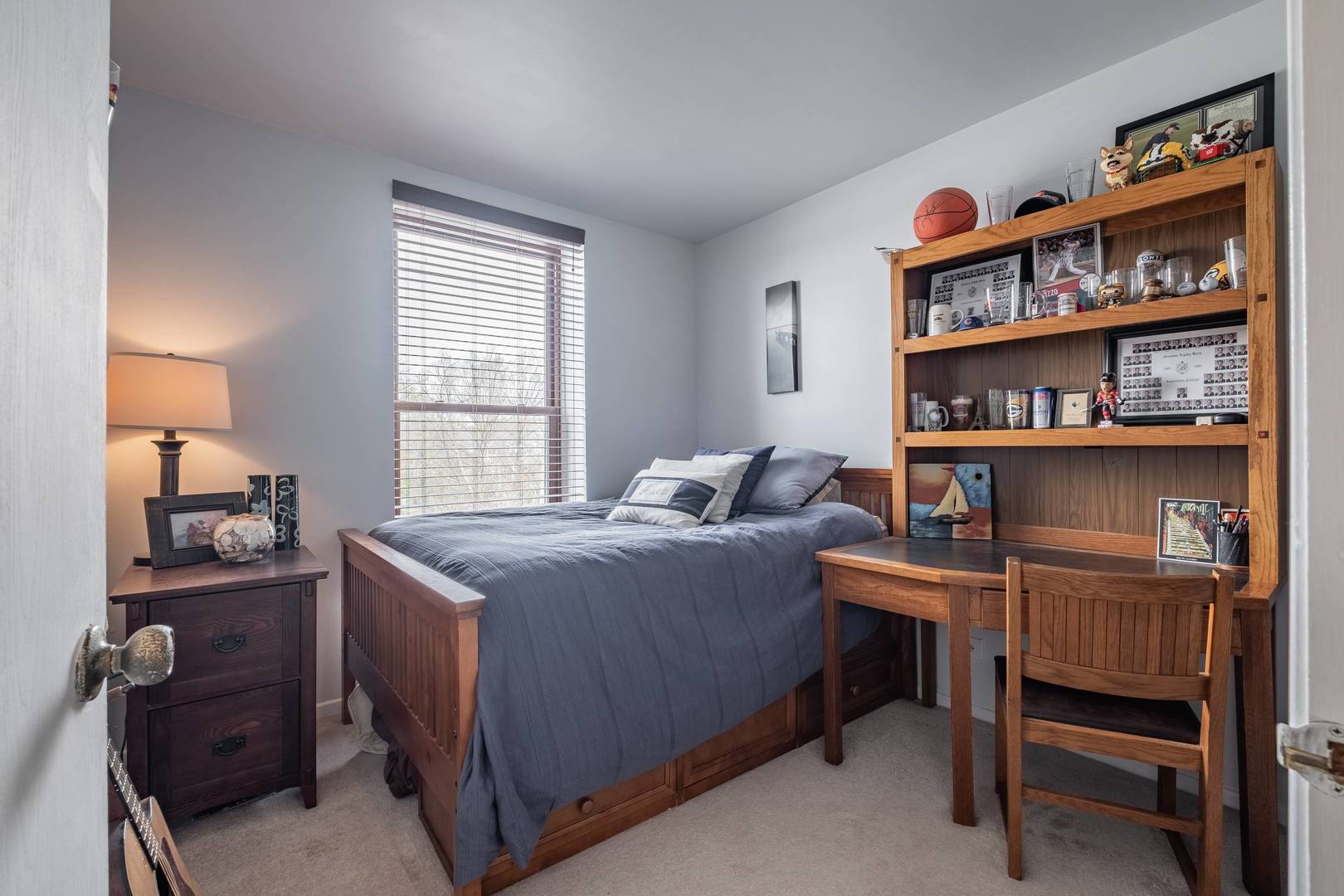 759 North Old Rand Road Lake Zurich, IL 60047 - Photo 24 of 34 a bedroom with a bed a table and a bookshelf