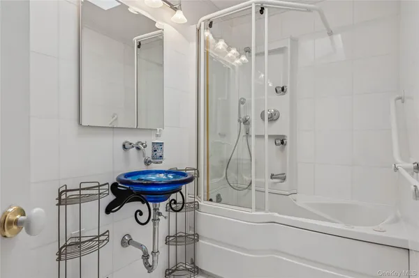 a bathroom with a shower and a mirror