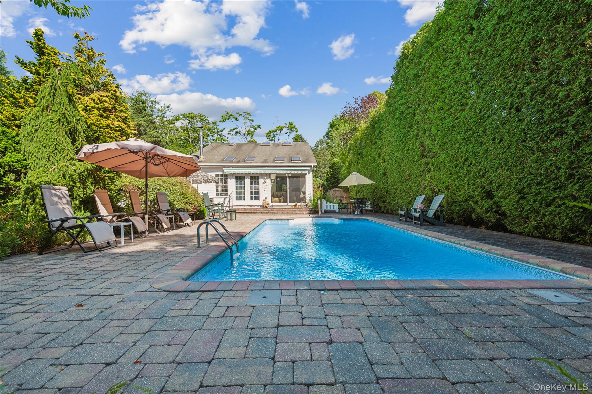 35 Halsey Road Remsenburg, NY 11960 - Photo 14 of 17 a view of a house with swimming pool and sitting area
