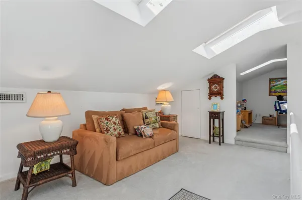 a living room with furniture and a lamp