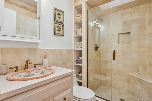 a bathroom with a sink toilet and shower