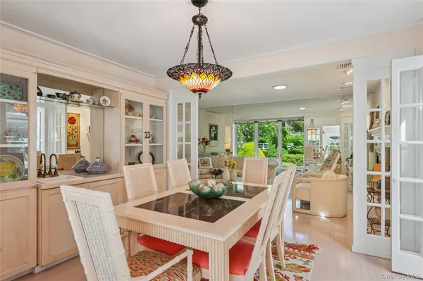 a dining room with furniture a chandelier and wooden floor