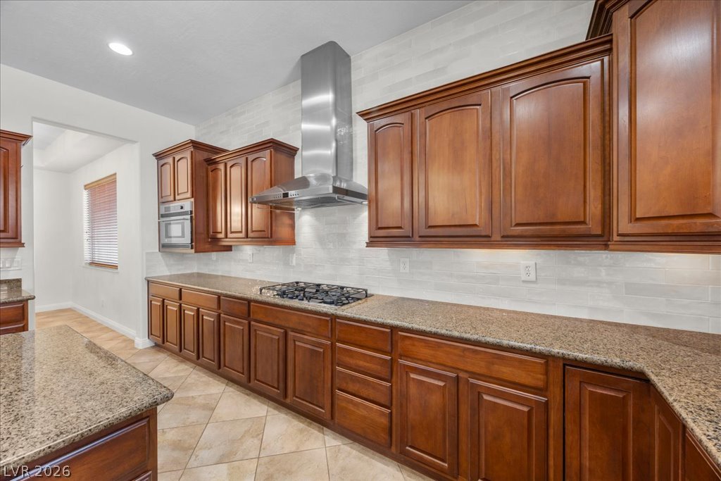 2125 De Rouge Avenue Henderson, NV 89044 - Photo 40 of 96 Culinary delights await in this chef-ready kitchen featuring rich wood cabinetry and ample counter space.