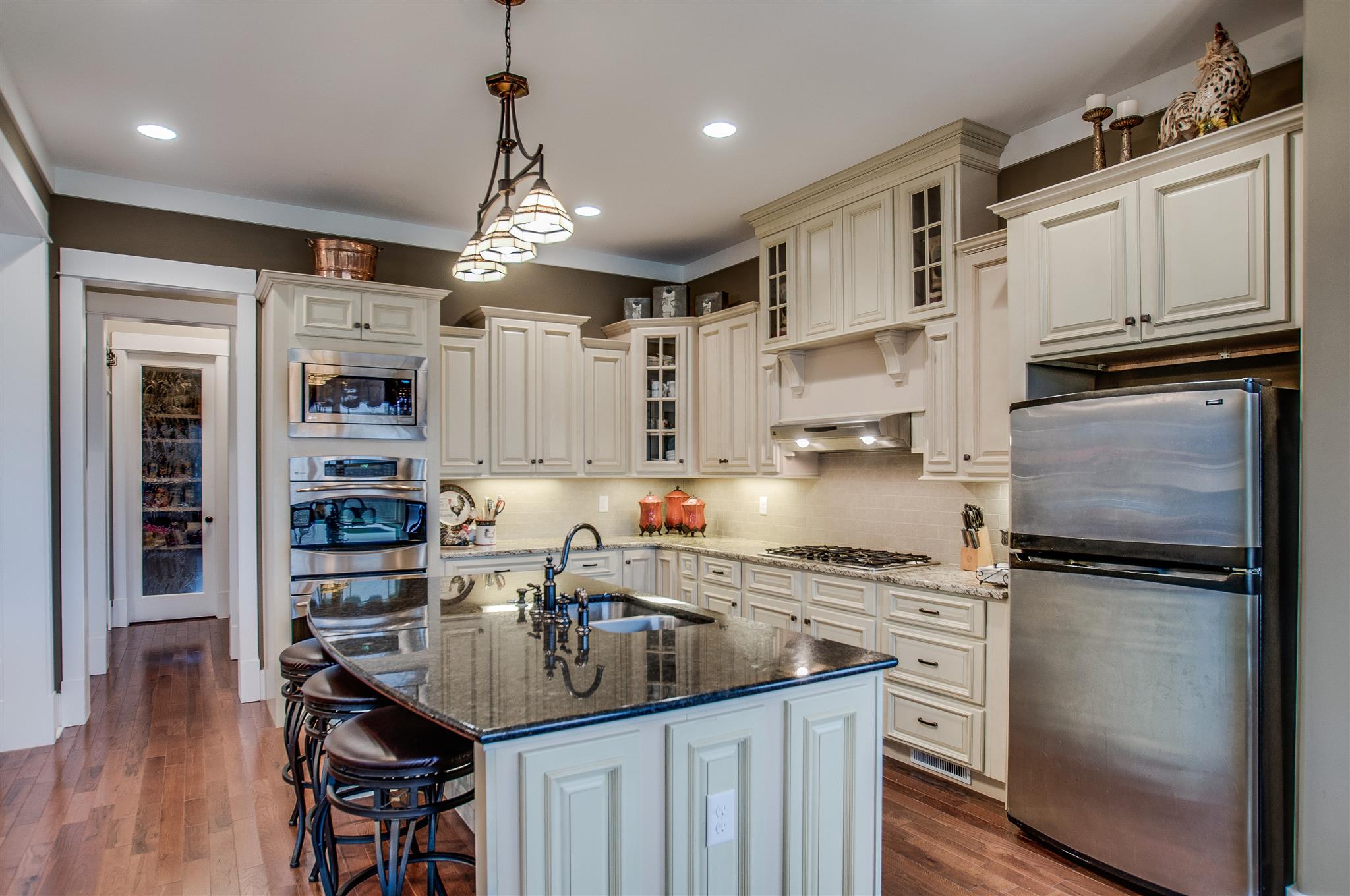 2533 Belle Brook Drive Franklin, TN 37067 - Photo 14 of 30 a kitchen with stainless steel appliances granite countertop a refrigerator oven a sink dishwasher and a stove with wooden floor