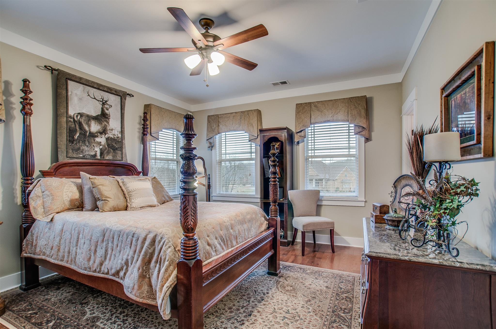 2533 Belle Brook Drive Franklin, TN 37067 - Photo 26 of 30 a bedroom with a large bed and a chandelier
