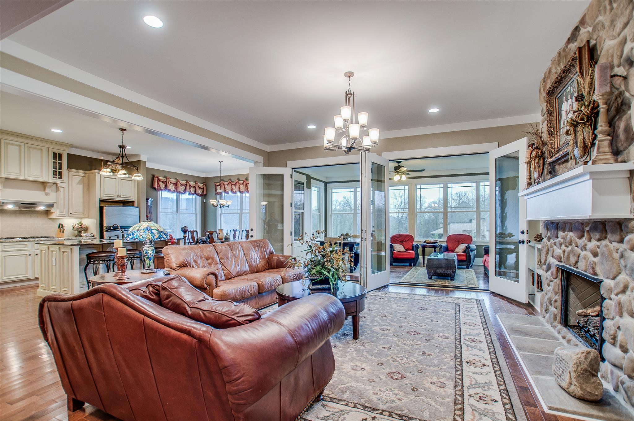 2533 Belle Brook Drive Franklin, TN 37067 - Photo 8 of 30 a living room with furniture a fireplace and a chandelier